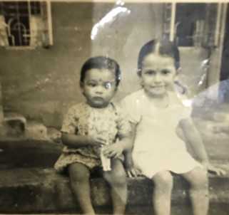 A childhood photo of Lakshmi Raman with her sister (Photo Credit: Lakshmi Raman)